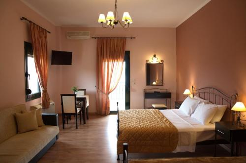 a hotel room with a bed and a couch at Hotel Agnanti Unique Hospitality in Kastoria