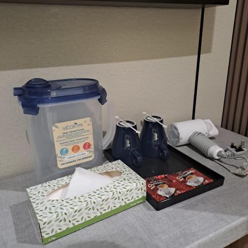 a counter with a container and a box on a table at Urban Inn, Myra Meranti in Cyberjaya