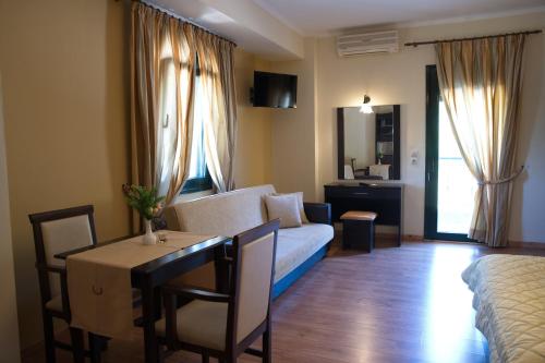 a living room with a couch and a table with a dining room at Hotel Agnanti Unique Hospitality in Kastoria