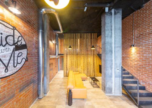 a room with yellow couches and a brick wall at ART LOFTS Valencia by Benisur in Valencia