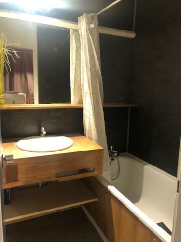 une salle de bain avec un lavabo et une baignoire dans l'établissement L'appartement Tom d'Avoriaz, à Avoriaz