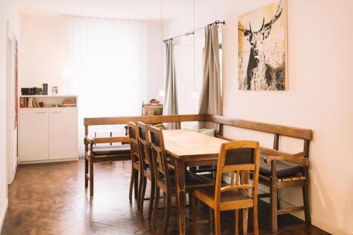 a dining room with a wooden table and chairs at Weingut Petershof in Alzey