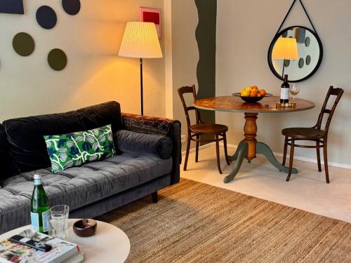 a living room with a couch and a table at Harborside Studio Apt Walk to Shops Eateries in Sydney