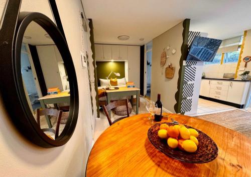 a table with a bowl of fruit and a mirror at Harborside Studio Apt Walk to Shops Eateries in Sydney