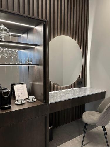 a dressing room with a mirror and a chair at Boutique Hotel Light House Jurmala in Jūrmala