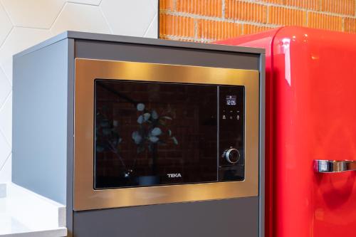 a microwave oven next to a red refrigerator at ART LOFTS Valencia by Benisur in Valencia