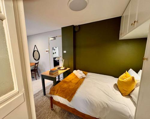 a bedroom with a bed with a green wall at Harborside Studio Apt Walk to Shops Eateries in Sydney