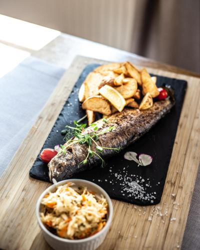 a plate of food with fish and chips on a table at Pod Kolumnami in Pilica