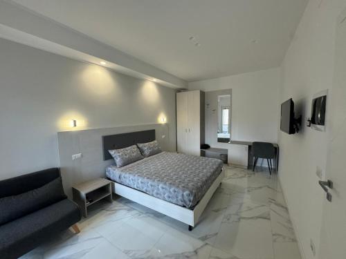 a bedroom with a bed and a couch and a desk at Alba White in Rome