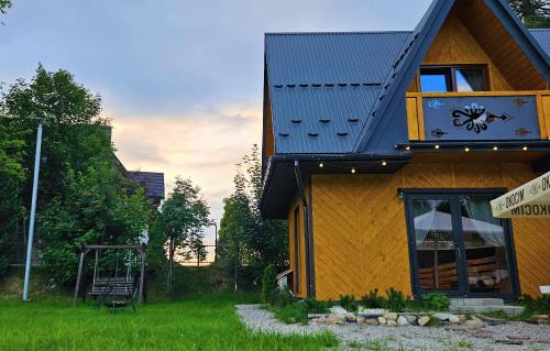 a building with a sign in front of it at ECO Domek z dużym ogrodem i widokiem in Murzasichle