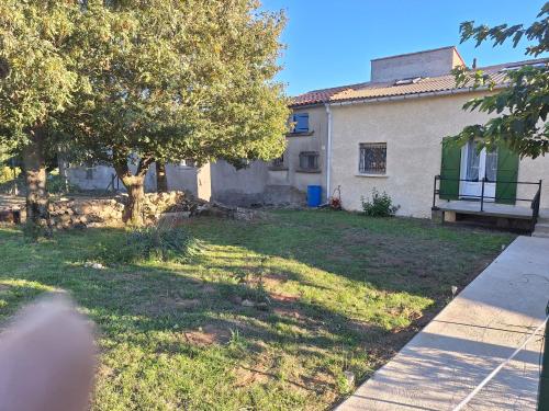a house with a yard with trees and a building at Chez Loulou du Linas - Bugarach in Bugarach