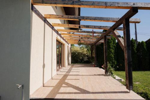 a pergola over a walkway on a house at Casa Korman in Giarmata