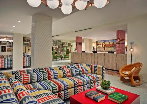 a living room with a couch and a table at Graduate by Hilton Tempe in Tempe