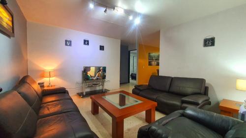 a living room with a couch and a coffee table at Expo gdl y col americana in Guadalajara