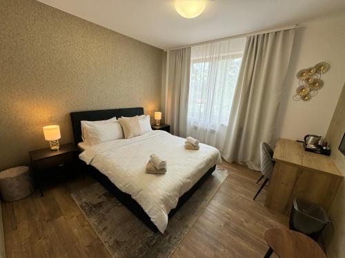 a bedroom with a bed with two towels on it at Penzion 4 pokoje in Prostějov
