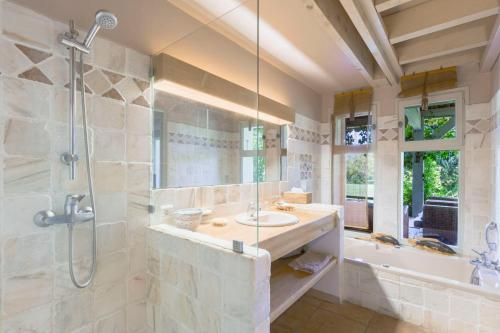 une salle de bain avec douche et lavabo dans l'établissement Souvenirs Intemporels, à Arles