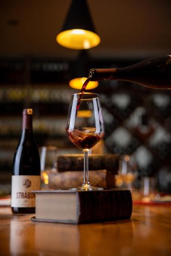 a bottle of wine being poured into a wine glass at Anemon Kent Ankara Otel in Ankara