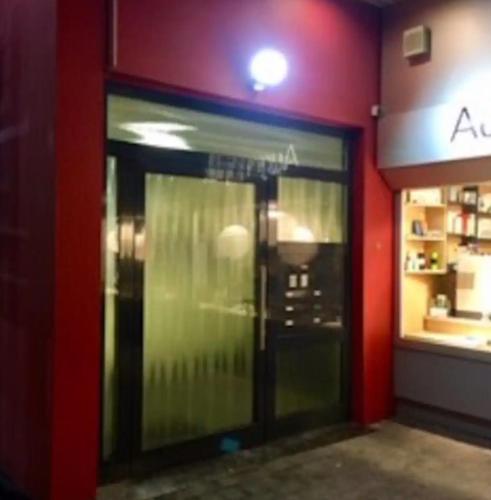 an entrance to a store with a glass door at Kleines Apartment mitten in Bergneustadt in Bergneustadt