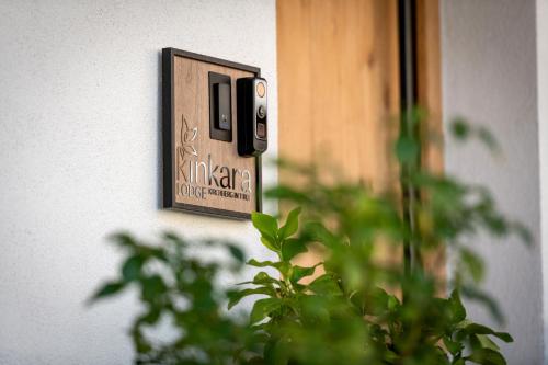 a switch on a wall next to a plant at Kinkara Lodge by Apartment Managers in Kirchberg in Tirol