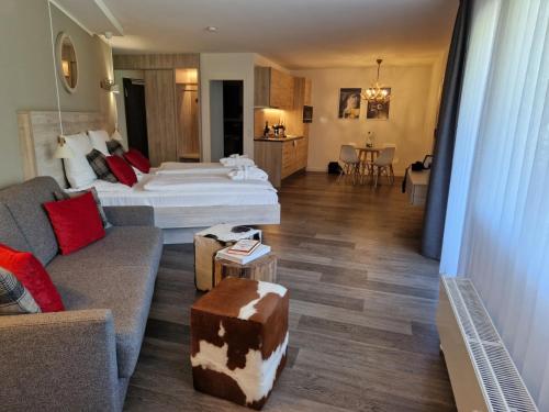 a hotel room with a bed and a couch at Ferienappartment Marianne in Schliersee