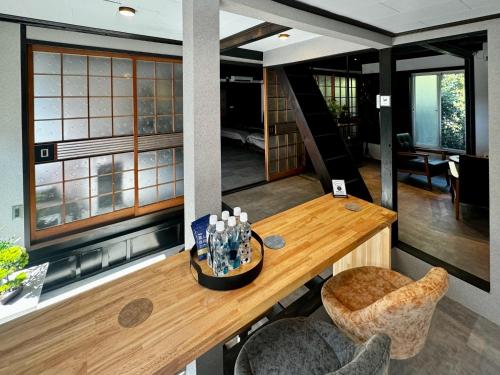 a room with a wooden table and some chairs at 加美屋リゾート淡路 波枕うずしお-Kamiya Resort Awaji in Minamiawaji