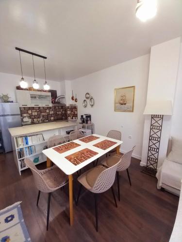 a kitchen and dining room with a table and chairs at Аpartment Van Gogh in Hisarya