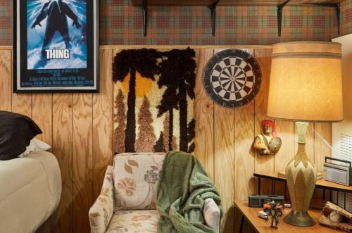 a room with a dart board on the wall and a chair at Graduate by Hilton Bloomington in Bloomington