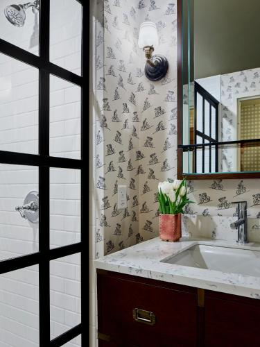 a bathroom with a sink and a mirror at Graduate by Hilton Bloomington in Bloomington