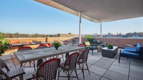a patio with a table and chairs on a roof at Graduate by Hilton Bloomington in Bloomington