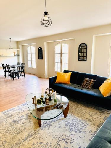 un salon avec un canapé bleu et une table en verre dans l'établissement love to bordeaux triangle d'or 2 bedrooms, à Bordeaux