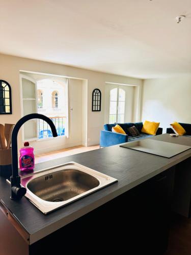 une cuisine avec un évier et un salon dans l'établissement love to bordeaux triangle d'or 2 bedrooms, à Bordeaux