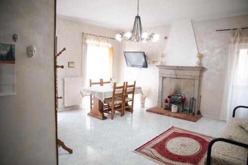 a living room with a table and a fireplace at I Cento Portali in Pignola