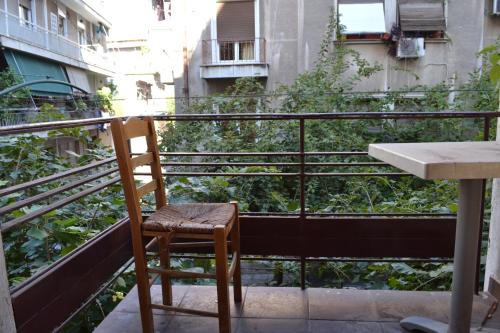 a chair sitting on top of a balcony at Argo Hotel in Athens