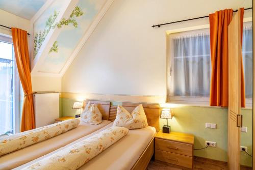 a room with a couch with pillows and a window at SCHUSTERjunge Aparthotel in Sasbachwalden