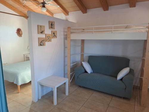 a living room with a couch and a bunk bed at Caseta del Riu in Deltebre