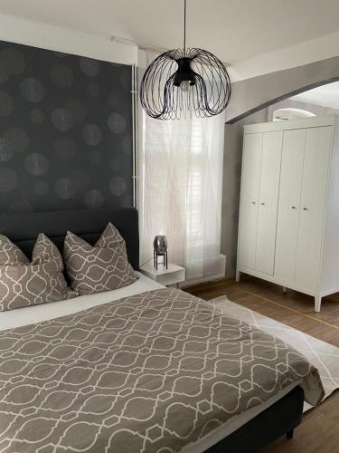 a bedroom with a large bed and a chandelier at Ferienwohnung in Bad Wildungen, Erdgeschoß in Bad Wildungen