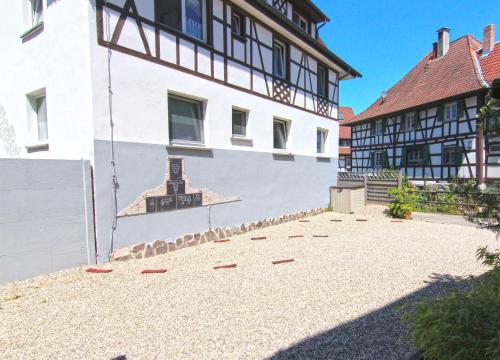 a building with a mural on the side of it at SCHUSTERjunge Aparthotel in Sasbachwalden