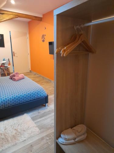 a bedroom with a bed and a closet at Chambre d'hôtes SOPHORA - Les Clés des Lys in Moret-sur-Loing