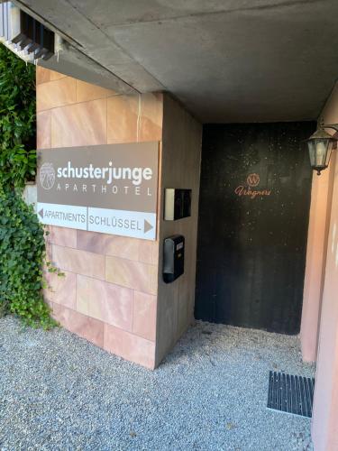 a sign on the side of a building at SCHUSTERjunge Aparthotel in Sasbachwalden