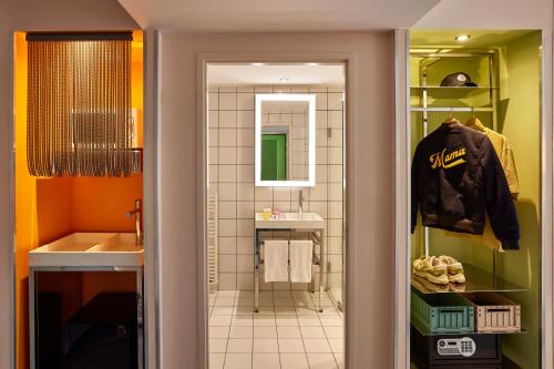 a bathroom with a walk in shower next to a sink at Mama Shelter Lyon in Lyon