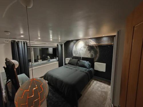 a bedroom with a bed and a moon painted on the wall at Cozy Blackpool Retreat with 3 Bedrooms in Blackpool