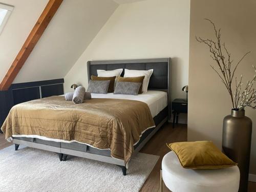 a bedroom with a large bed with pillows on it at LES GRANGES DE JADIS ALSACE Bis in Holtzwihr