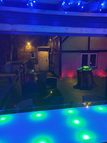 a view of a patio at night with green lights at Huge Cottage for Sophisticated Hen Party and Large Groups in Hurst