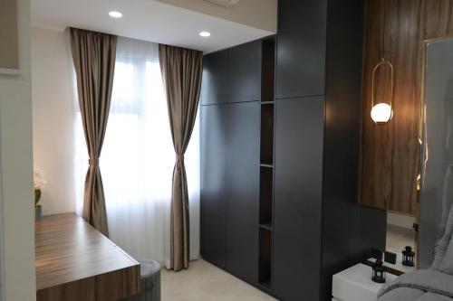 a bedroom with black walls and a window with curtains at Apartment Medan Podomoro City Deli by OLS Studio in Medan
