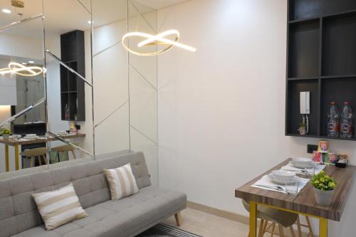 a living room with a couch and a table at Apartment Medan Podomoro City Deli by OLS Studio in Medan