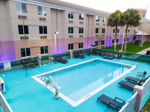 a large swimming pool in front of a building at Sleep Inn Ormond Beach - Daytona in Ormond Beach