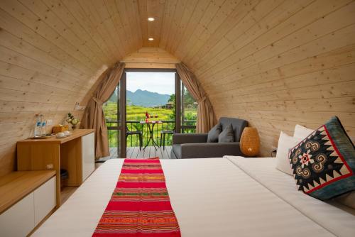 a room with a bed and a couch and a window at Puluong Valley Home in Pu Luong