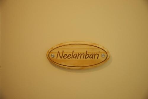 a sign on a wall that says new zealdain at Neelambari - Riverside Private Bedroom in Kumarakom