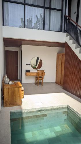 a house with a pool in the middle of a room at Sujiwa Ubud Hotel & Villa in Ubud