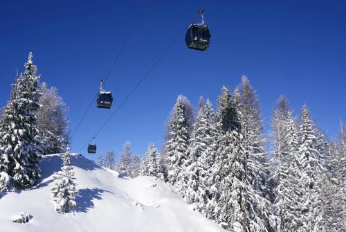 a ski lift in the snow with snow covered trees at Club Alpina - Champagny-en-Vanoise in Champagny-en-Vanoise